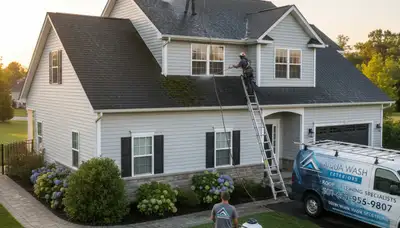 Technician performing roof cleaning on residential home in Greensboro, NC